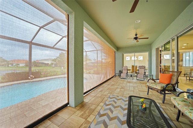 sunroom featuring a ceiling fan