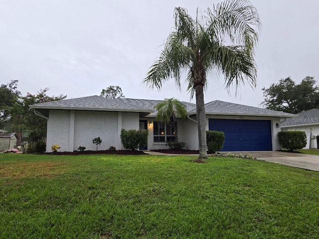 3753 Aba Ln, North Port, FL 34287 - view of front facade featuring stucco siding, driveway, a garage, and a front lawn