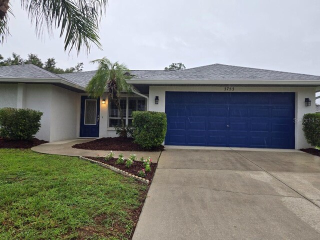 3753 Aba Ln, North Port, FL 34287 - ranch-style home featuring stucco siding, an attached garage, concrete driveway, and roof with shingles