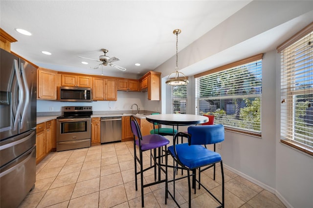 3753 Aba Ln, North Port, FL 34287 - kitchen with appliances with stainless steel finishes, healthy amount of natural light, light countertops, recessed lighting, and decorative light fixtures