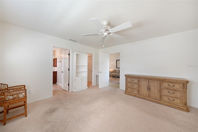 3753 Aba Ln, North Port, FL 34287 - bedroom featuring light carpet, a spacious closet, ensuite bathroom, a ceiling fan, and a closet
