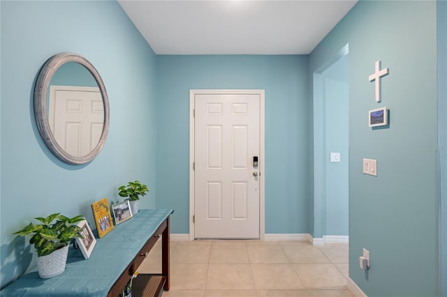 entryway featuring light tile patterned floors and baseboards