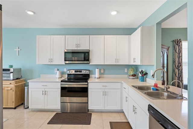 kitchen featuring a sink, light countertops, white cabinets, and appliances with stainless steel finishes