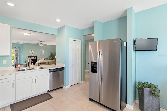 kitchen with light countertops, a ceiling fan, white cabinets, stainless steel appliances, and a sink