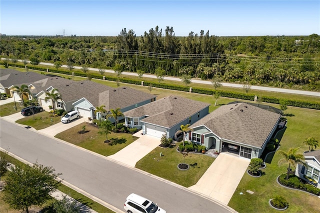 bird's eye view with a wooded view