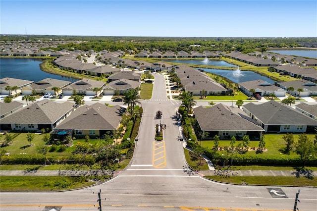 drone / aerial view with a water view and a residential view