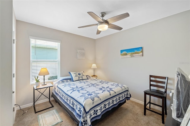carpeted bedroom featuring baseboards and ceiling fan