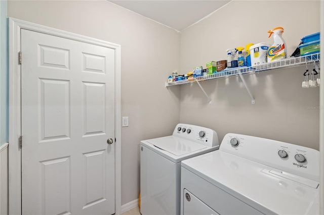 laundry area featuring laundry area, washing machine and clothes dryer, and baseboards