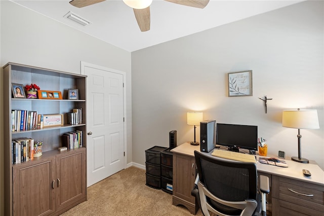 office area with baseboards, visible vents, light colored carpet, and a ceiling fan