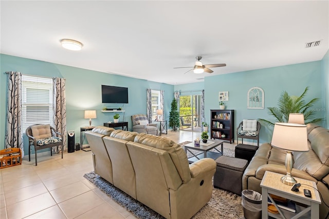 living room with visible vents, light tile patterned flooring, and ceiling fan