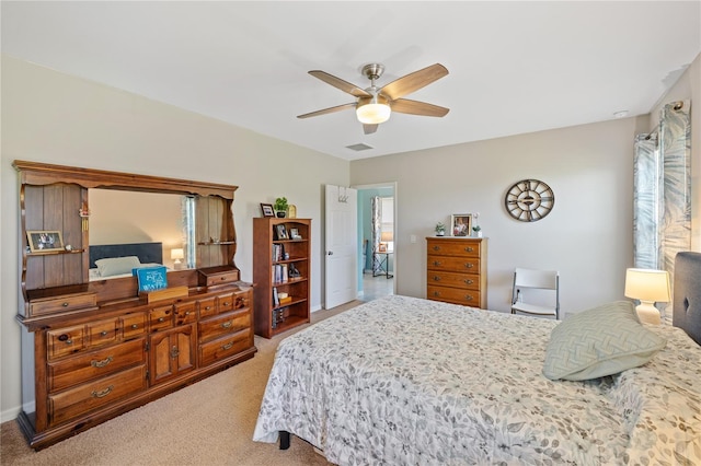 bedroom featuring light colored carpet, a ceiling fan, and visible vents