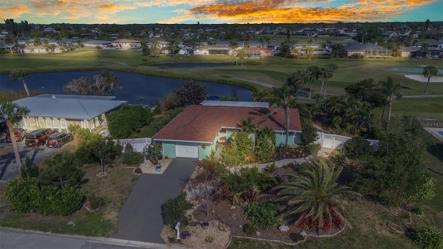 aerial view of property and surrounding area featuring nearby suburban area, a large body of water, and a golf club
