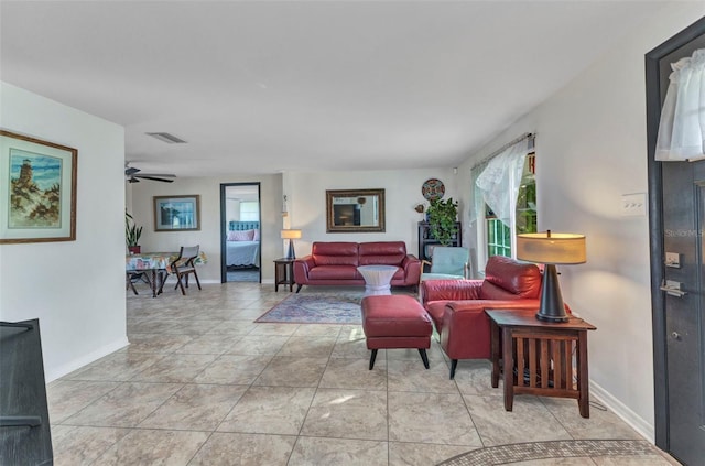 living room featuring baseboards and a ceiling fan
