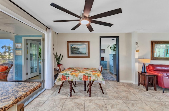 dining room with ceiling fan and baseboards