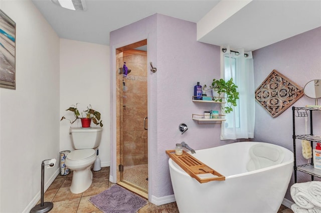full bathroom featuring a stall shower, toilet, a soaking tub, and baseboards