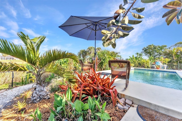 view of swimming pool featuring fence
