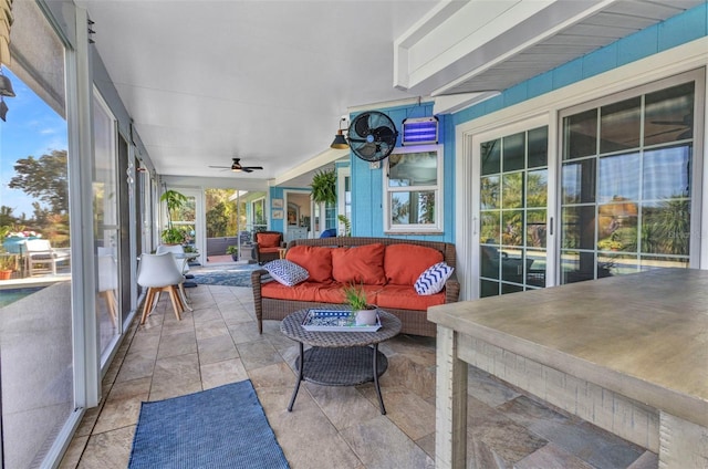 sunroom featuring ceiling fan and an outdoor hangout area