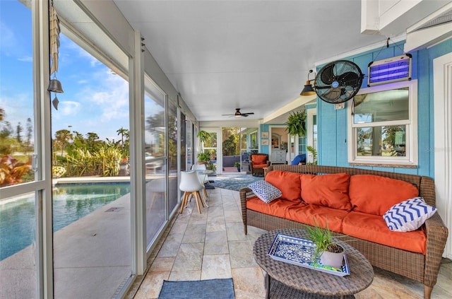 sunroom / solarium with an outdoor living space and ceiling fan