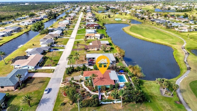 aerial overview of property's location with nearby suburban area, a nearby body of water, and a local golf course