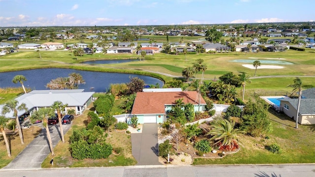 aerial view of residential area with a large body of water and a golf course