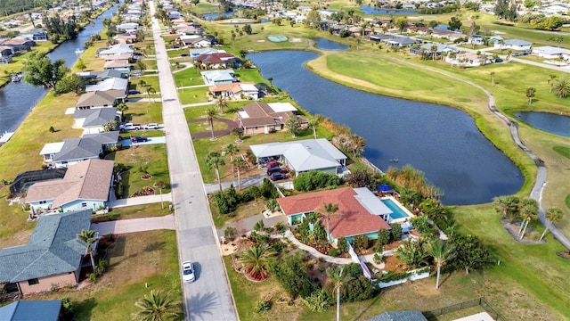 view of property location featuring nearby suburban area, a large body of water, and a local golf course