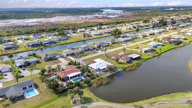 aerial view of property's location with nearby suburban area and a nearby body of water
