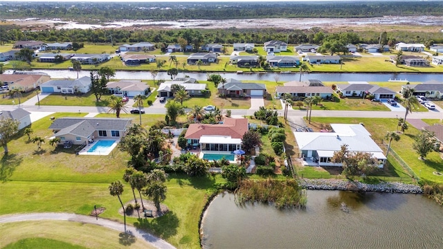 aerial perspective of suburban area with a large body of water and a pool