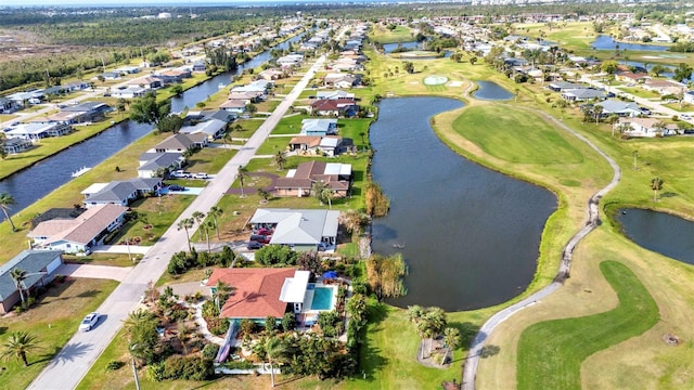 view of property location with nearby suburban area, a large body of water, and a golf course