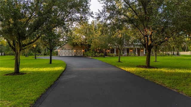 9990 SW Peace River St, Arcadia, FL 34269 - view of front of home featuring driveway, a front yard, and an attached garage