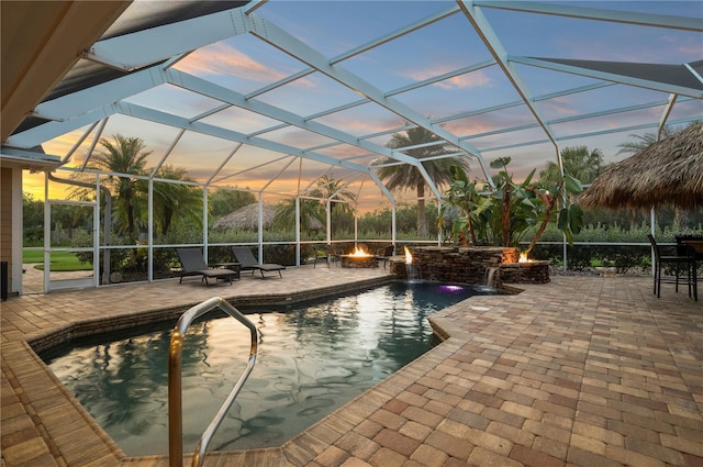 9990 SW Peace River St, Arcadia, FL 34269 - outdoor pool featuring an outdoor fire pit, a patio, and glass enclosure