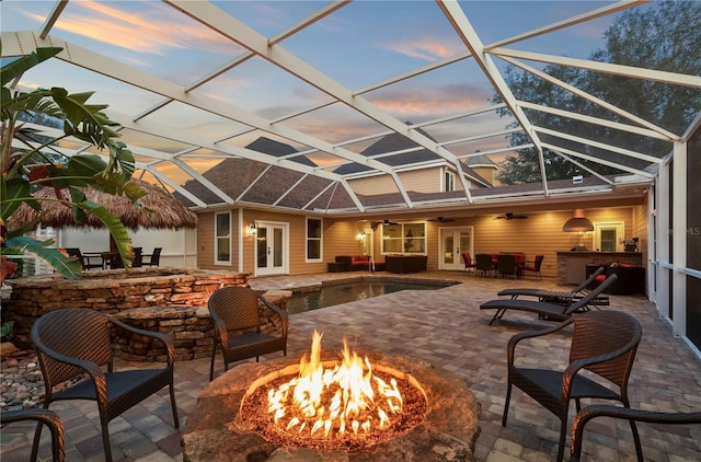 9990 SW Peace River St, Arcadia, FL 34269 - back of property featuring french doors, an outdoor fire pit, a ceiling fan, a patio area, and an outdoor pool