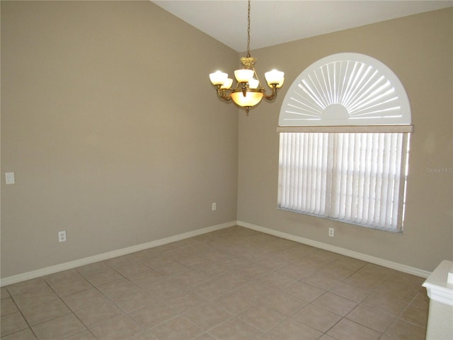 empty room with light tile patterned floors, a notable chandelier, baseboards, and vaulted ceiling