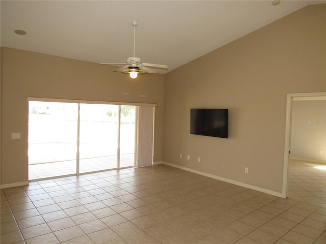 spare room with baseboards, high vaulted ceiling, light tile patterned floors, and a ceiling fan