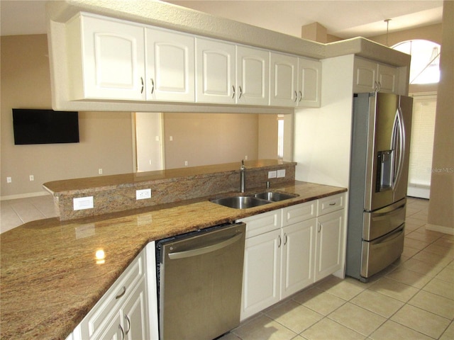 kitchen featuring white cabinets, a sink, stainless steel appliances, and light tile patterned floors
