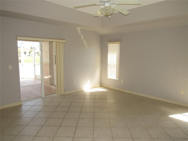 spare room with light tile patterned floors, baseboards, and a ceiling fan
