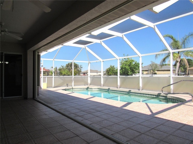 pool with a lanai, a ceiling fan, and a patio area