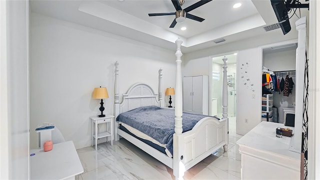 bedroom featuring visible vents, recessed lighting, a walk in closet, and a raised ceiling