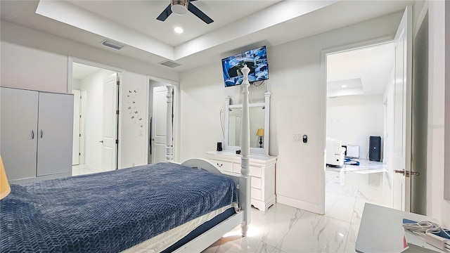 bedroom featuring marble finish floor, a tray ceiling, visible vents, and recessed lighting