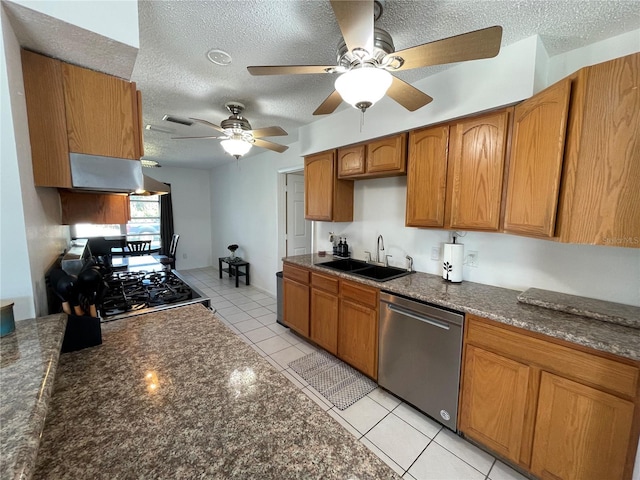 kitchen featuring range hood, dishwasher, a ceiling fan, a sink, and brown cabinetry