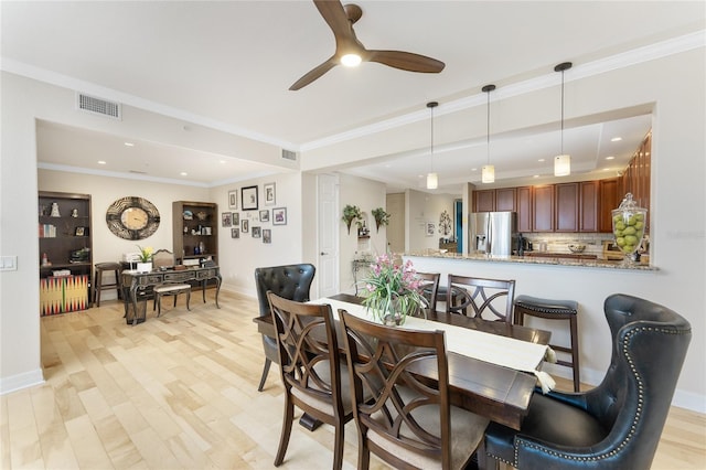 dining area with visible vents, a ceiling fan, baseboards, and light wood-type flooring