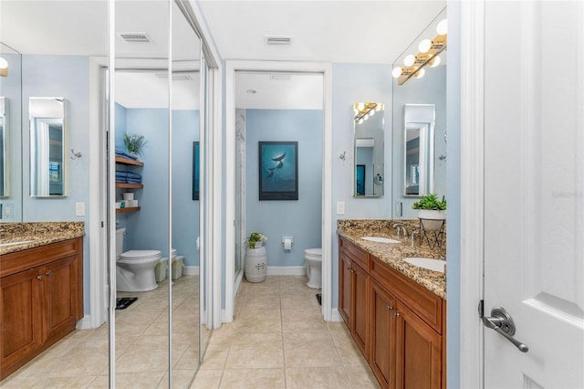full bathroom featuring a sink, double vanity, toilet, tile patterned floors, and visible vents