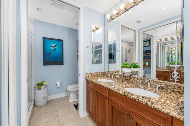 bathroom featuring a sink, baseboards, toilet, and visible vents