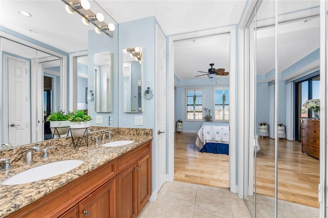 ensuite bathroom featuring a sink, ceiling fan, ensuite bathroom, and double vanity
