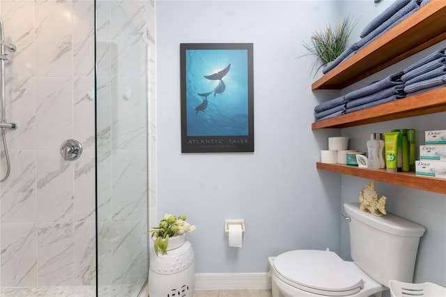 bathroom with a marble finish shower and toilet