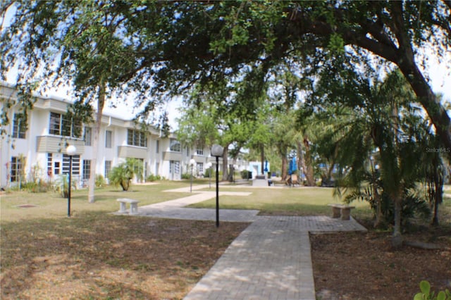 view of home's community featuring a lawn and a residential view