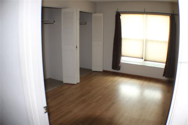 unfurnished bedroom featuring wood finished floors