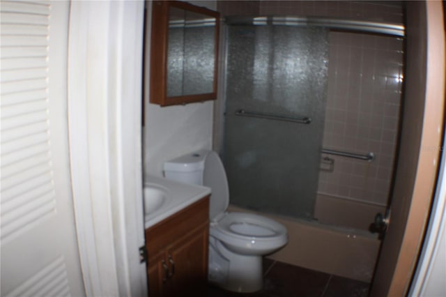 21320 Brinson Ave Unit 212, Port Charlotte, FL 33952 - bathroom featuring toilet, vanity, tile patterned floors, and enclosed tub / shower combo