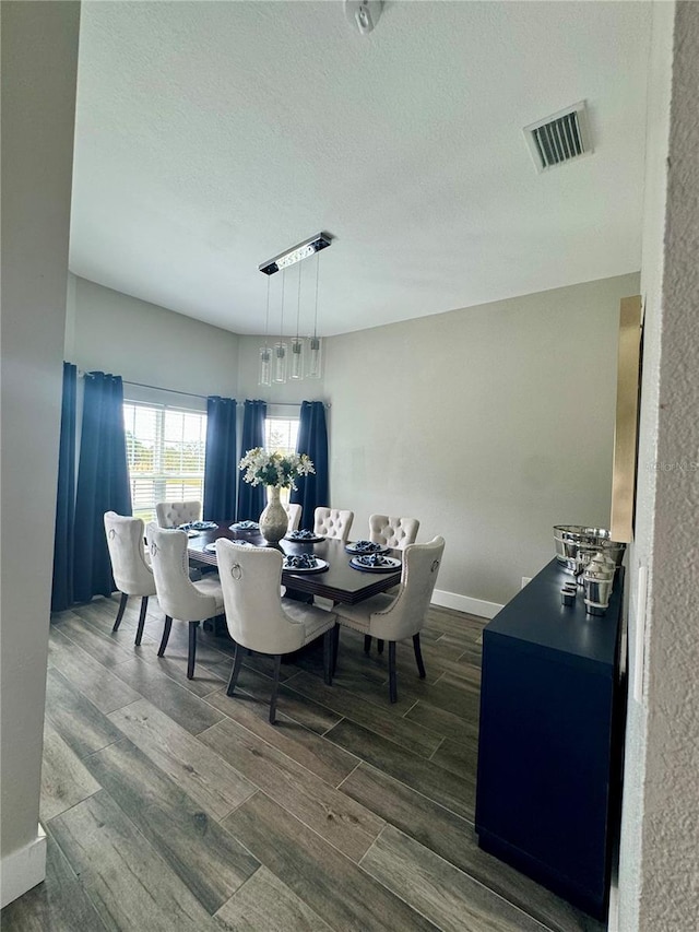 22223 Seyburn Ter, Port Charlotte, FL 33954 - dining space with visible vents, dark wood-style flooring, baseboards, and a textured ceiling
