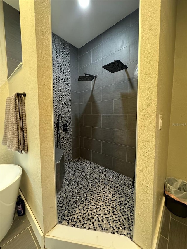 22223 Seyburn Ter, Port Charlotte, FL 33954 - bathroom featuring a freestanding tub, a textured wall, baseboards, and walk in shower