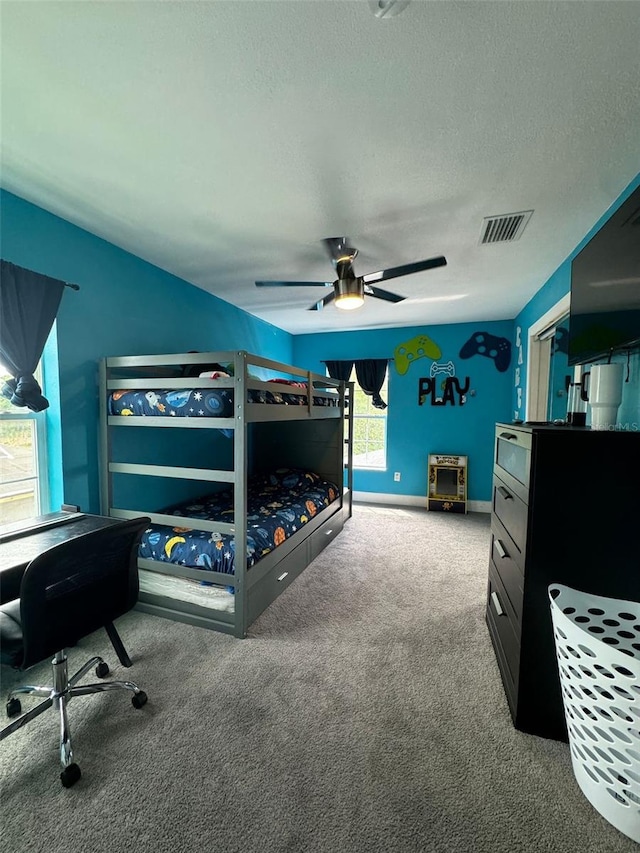 22223 Seyburn Ter, Port Charlotte, FL 33954 - carpeted bedroom with baseboards, visible vents, a textured ceiling, and a ceiling fan